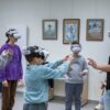Three children wearing VR headsets reaching for virtual objects during a history lesson at Harmonia Jeżyce Private Primary School