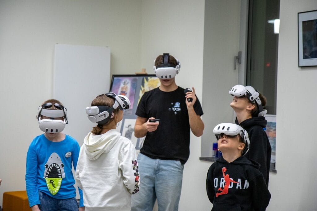 A group of pupils wearing VR headsets with an instructor during a history session at Harmonia Jeżyce Private Primary School