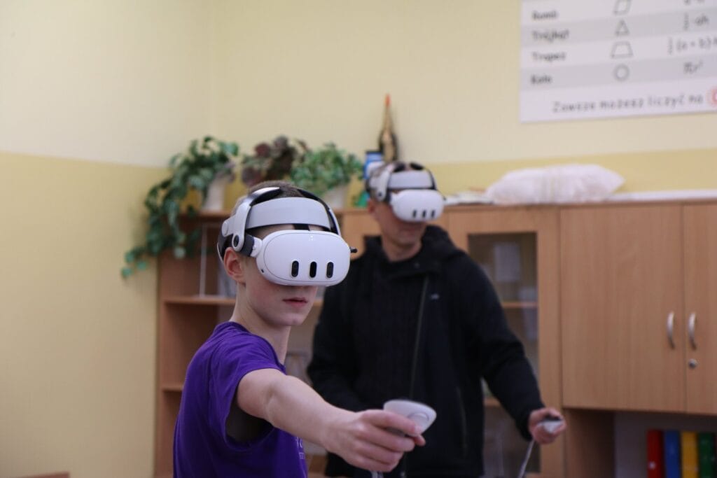 A pupil wearing a VR headset and holding a controller during a class at Harmonia Jeżyce Private Primary School