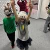 Pupils wearing VR headsets with their hands raised during a science workshop at Harmonia Nieszawska Primary School