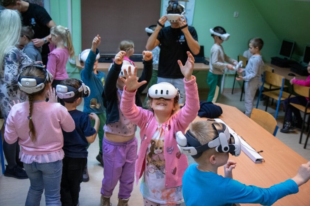 Pupils wearing VR headsets during a class in an attic classroom at Harmonia Nieszawska Primary School