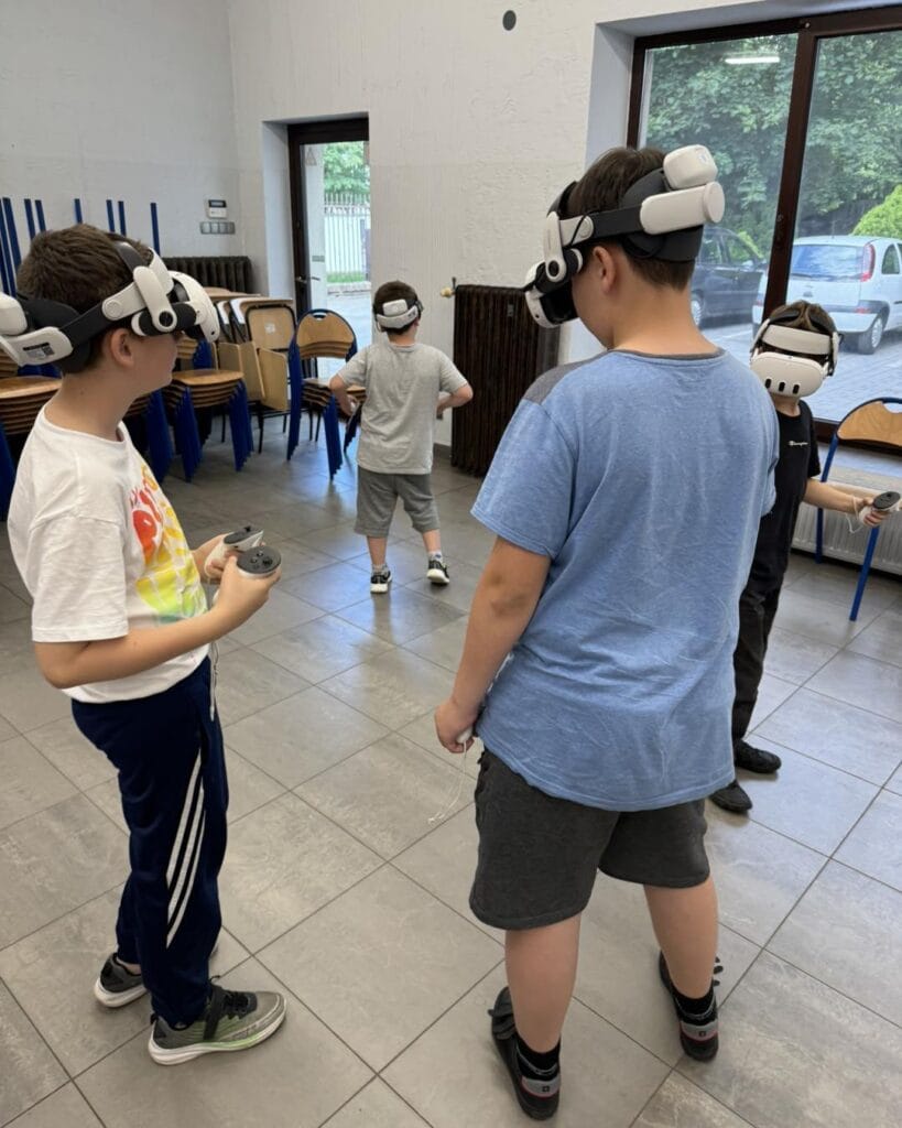 Boys wearing VR headsets during a class at Olimpus Primary School in Gutowo Małe