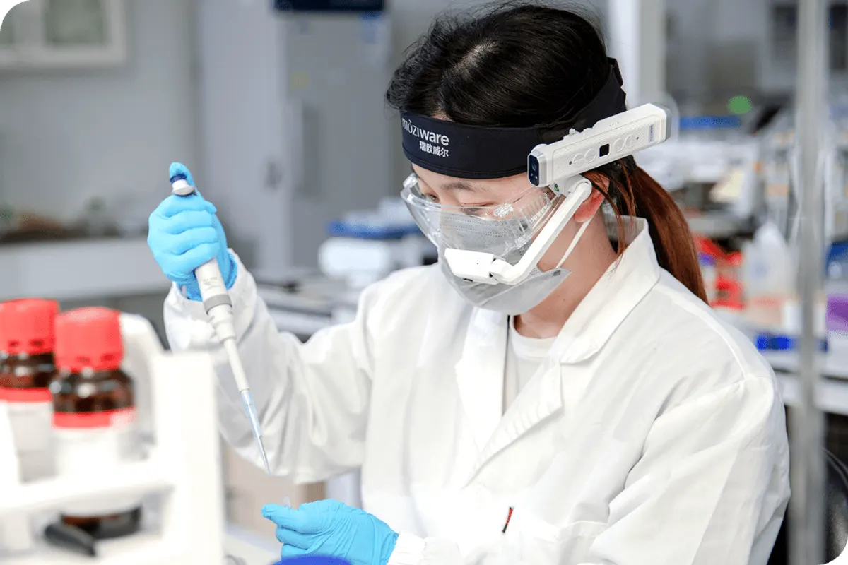 Moziware CIMO, Pracownica laboratorium w okularach Moziware CIMO na opasce podczas pracy z pipetą