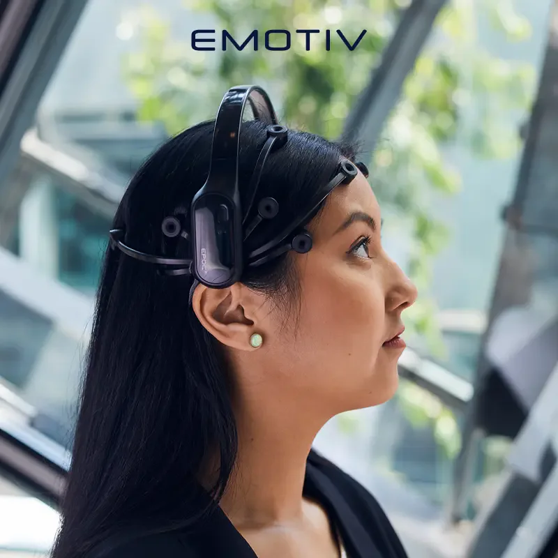 Side view of a woman wearing an EMOTIV EPOC X EEG headset