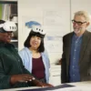 Instructor and two participants using Meta Quest headsets at a table