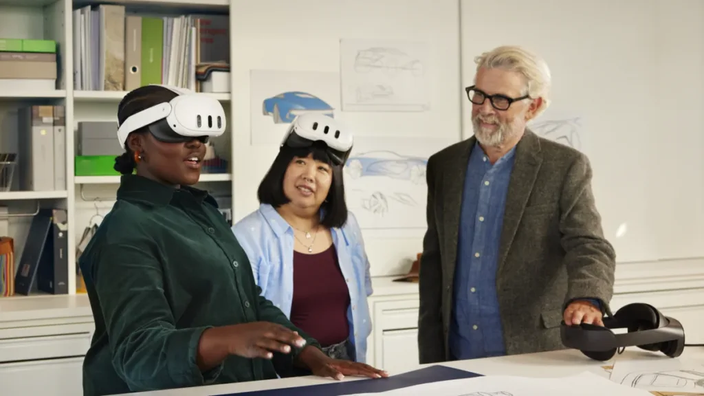 Instructor and two participants using Meta Quest headsets at a table