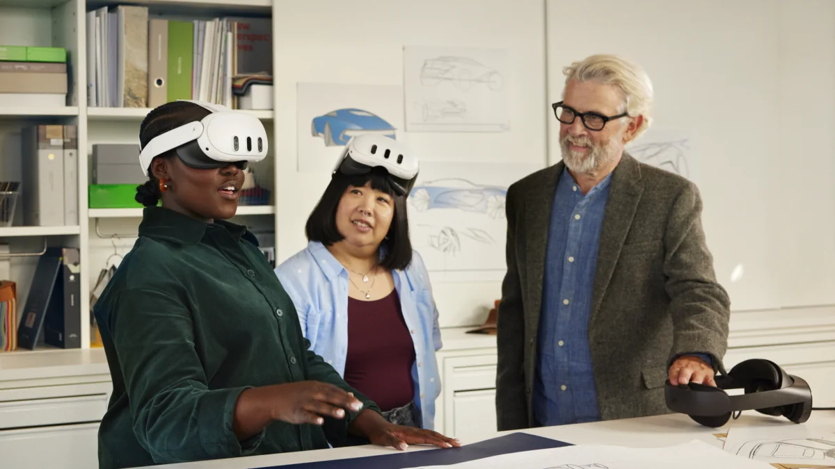 Instructor and two participants using Meta Quest headsets at a table