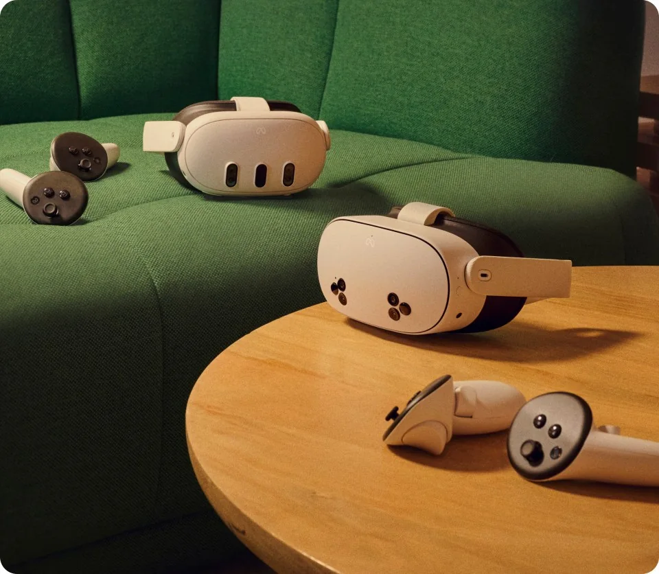 Meta Quest 3 and Quest 3S headsets with controllers on a table