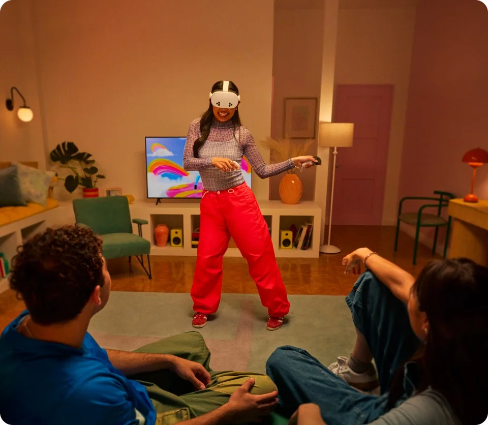 A woman using a Meta Quest 3S headset and controllers in a living room
