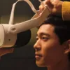 A user putting on a Meta Quest 3S headset with a fabric strap