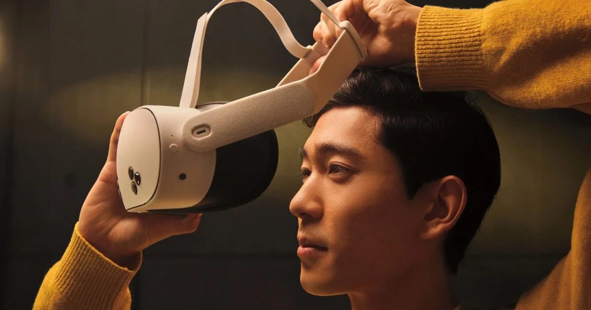 A user putting on a Meta Quest 3S headset with a fabric strap