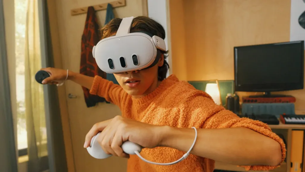 A boy in an orange hoodie using a Meta Quest headset and two controllers