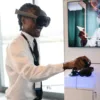 Attendee wearing a Quest Pro headset beside a monitor showing a training presentation at the Meta Future of Work Summit