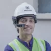 Worker in a hard hat and high-visibility clothing using a RealWear Navigator 520