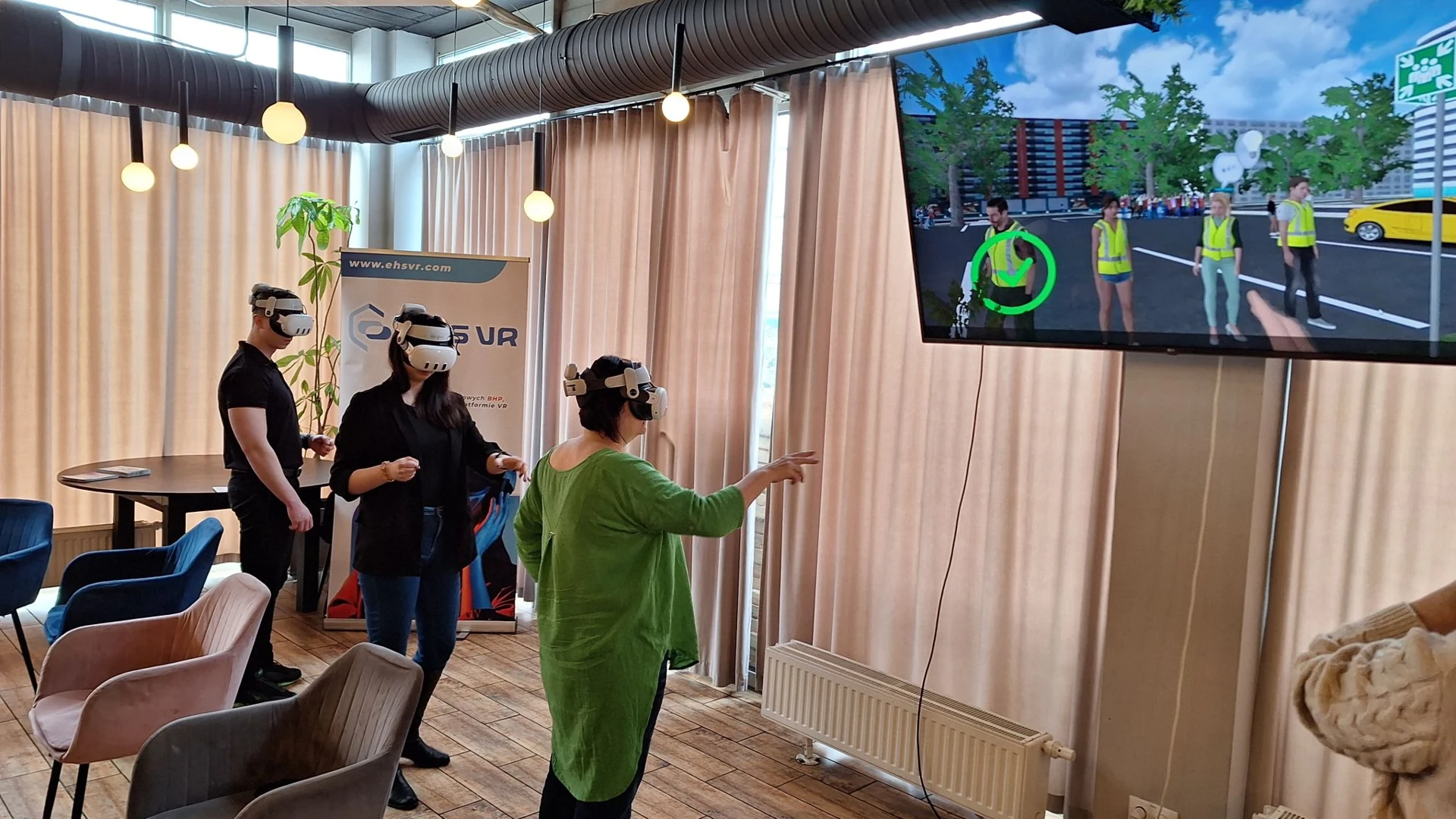 VR training participants and a screen showing the safety scenario