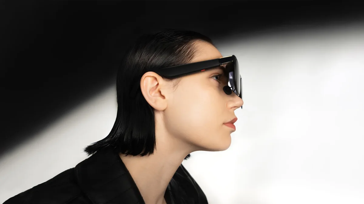 Side profile of a woman wearing XREAL One Pro glasses