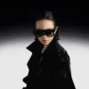 A woman wearing black XREAL One Pro glasses