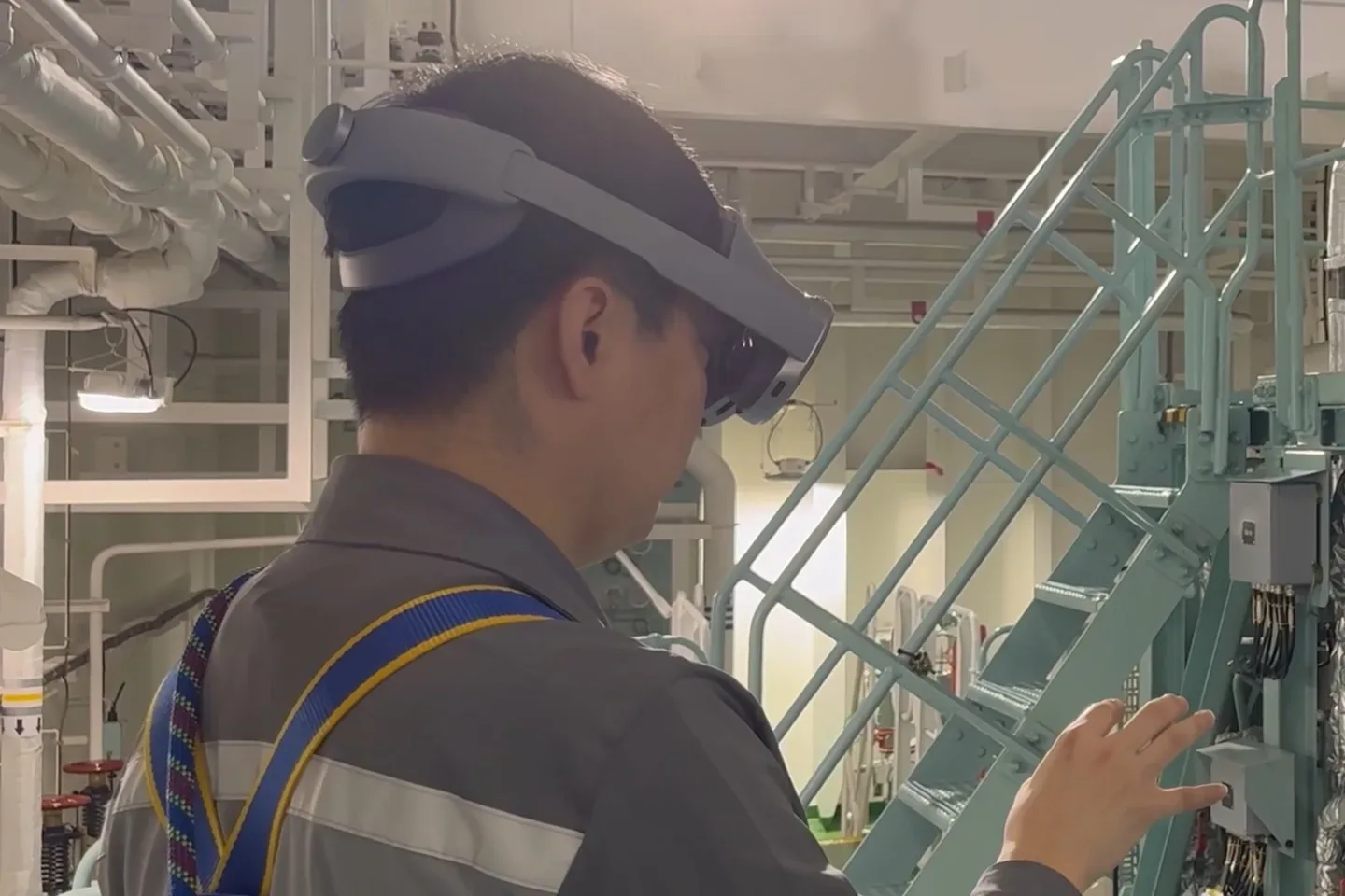 A man wearing Samsung Galaxy XR in an industrial facility